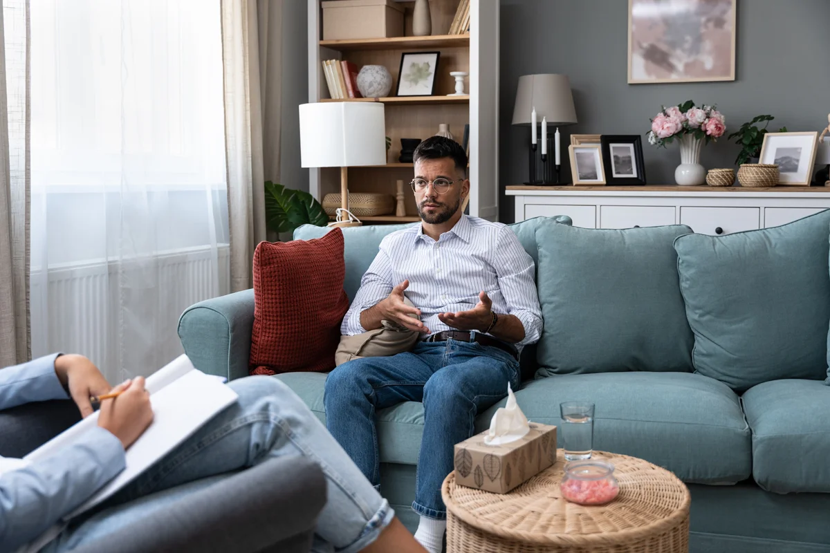 Man in counseling session on couch