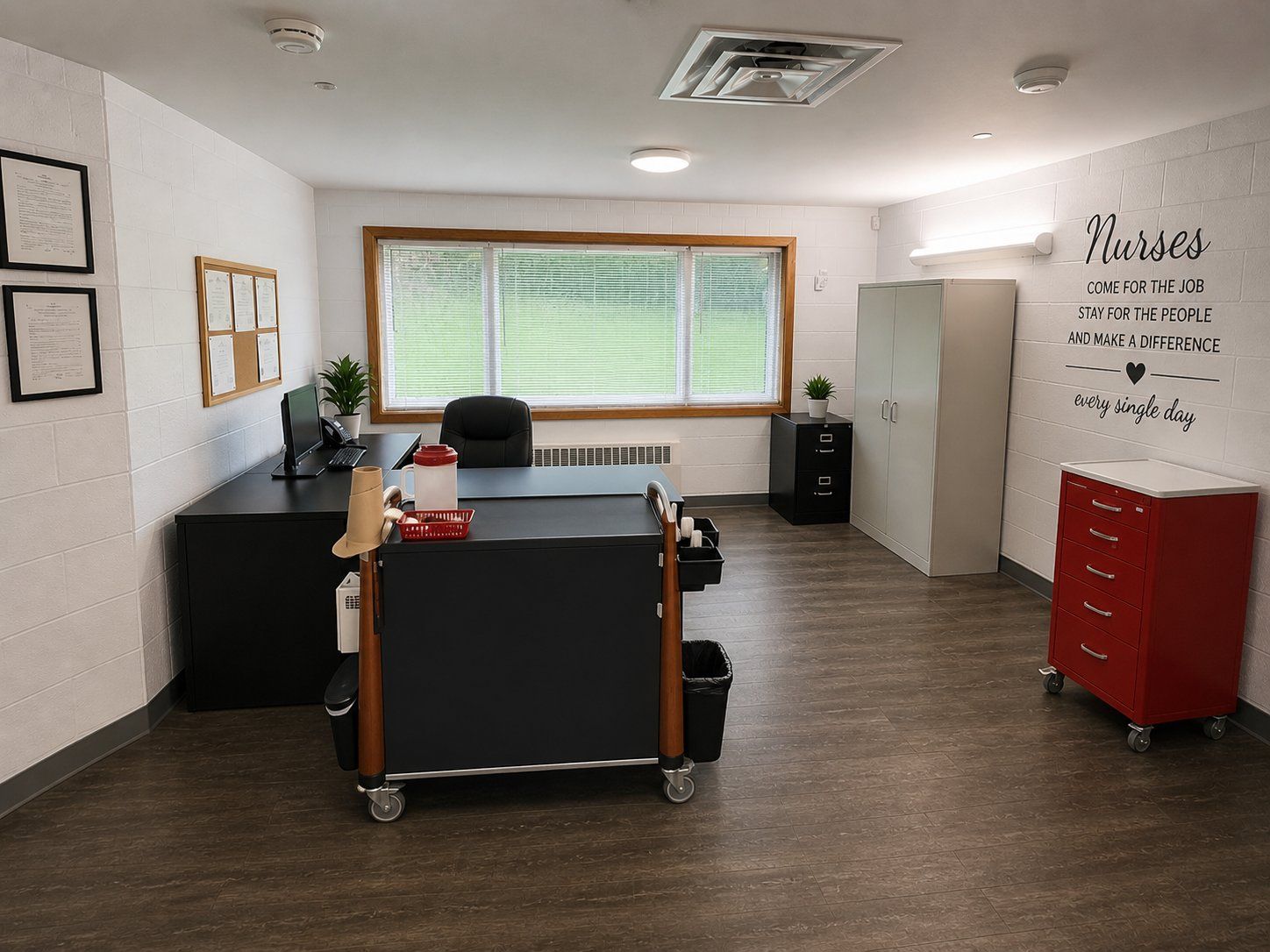 The nurses' station at Olympia Grove Recovery, with desks, a medication cart and a window onto the lawn