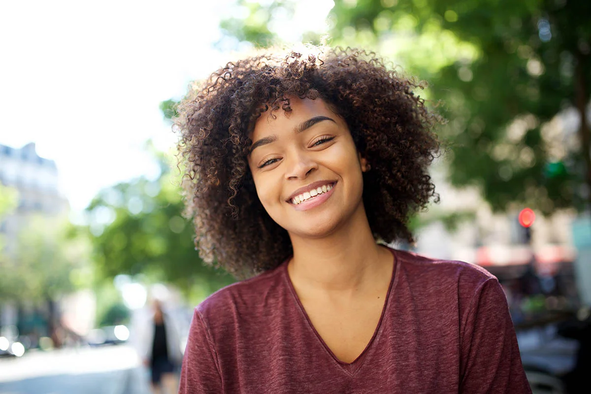 smiling woman is enjoying the sunny weather
